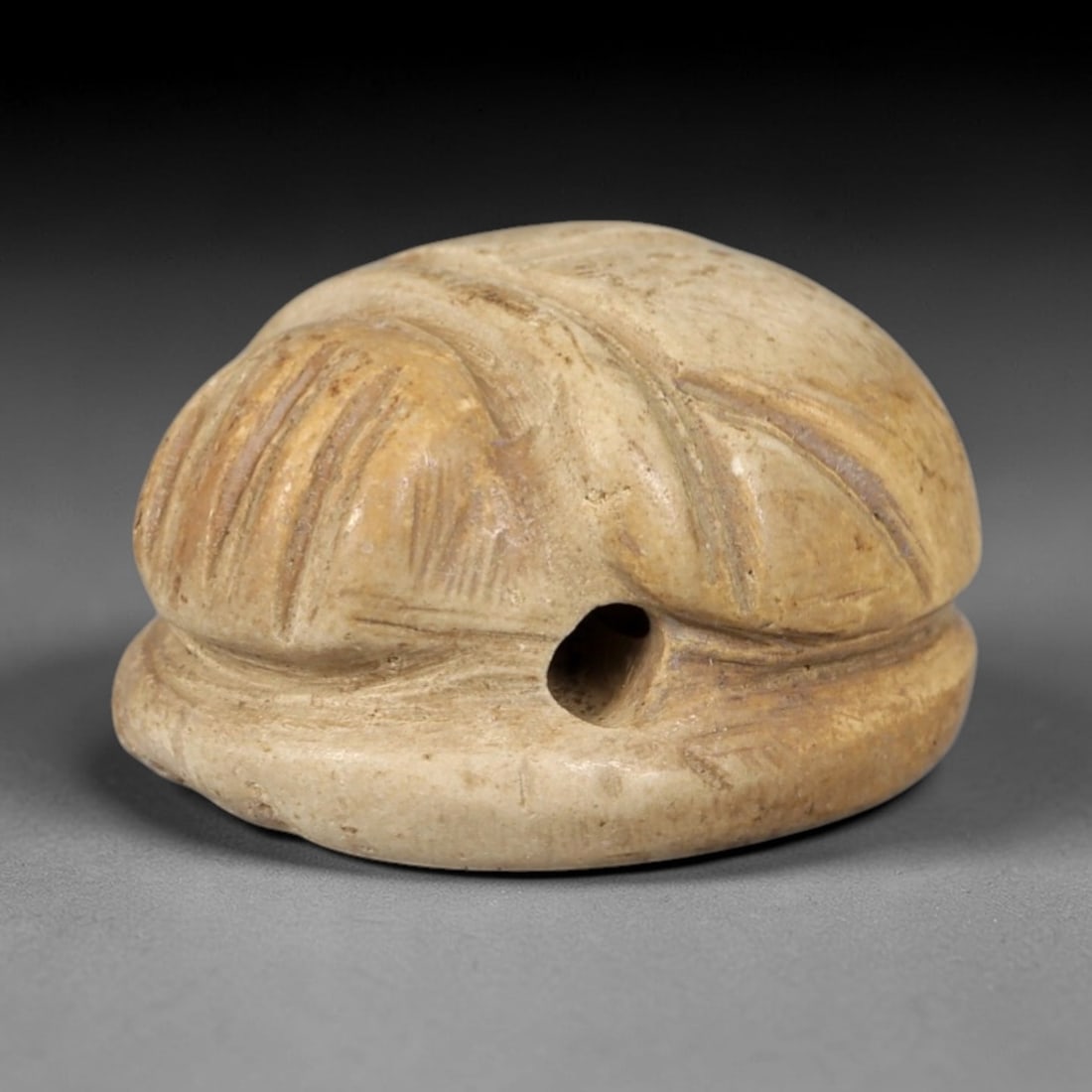 Ancient Steatite Scarab Amulet - Egyptian Figurine, 98AP: This artifact is carved from pale, creamy steatite, exhibiting a smooth, matte finish with subtle surface wear and natural mineral patterning consistent with age. The form is a compact scarab amulet, 