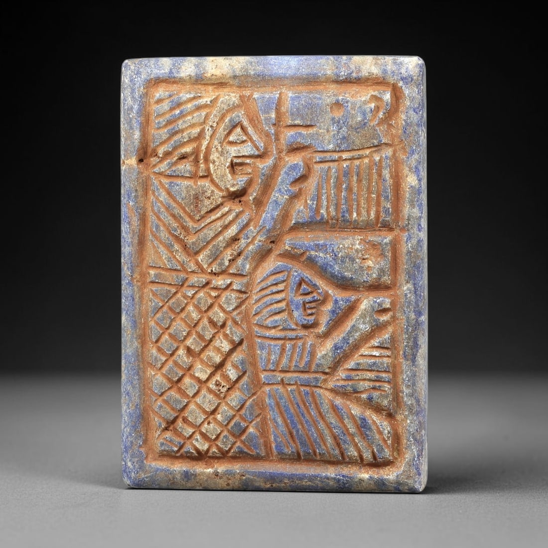 Near Eastern Lapis Lazuli Plaque - Tribal Art Two Figure Relief, 56BG: This Near Eastern tribal art plaque is carved from lapis lazuli, a semi-precious stone valued for its deep blue hue and suitability for intricate relief work. The rectangular plaque features a meticul