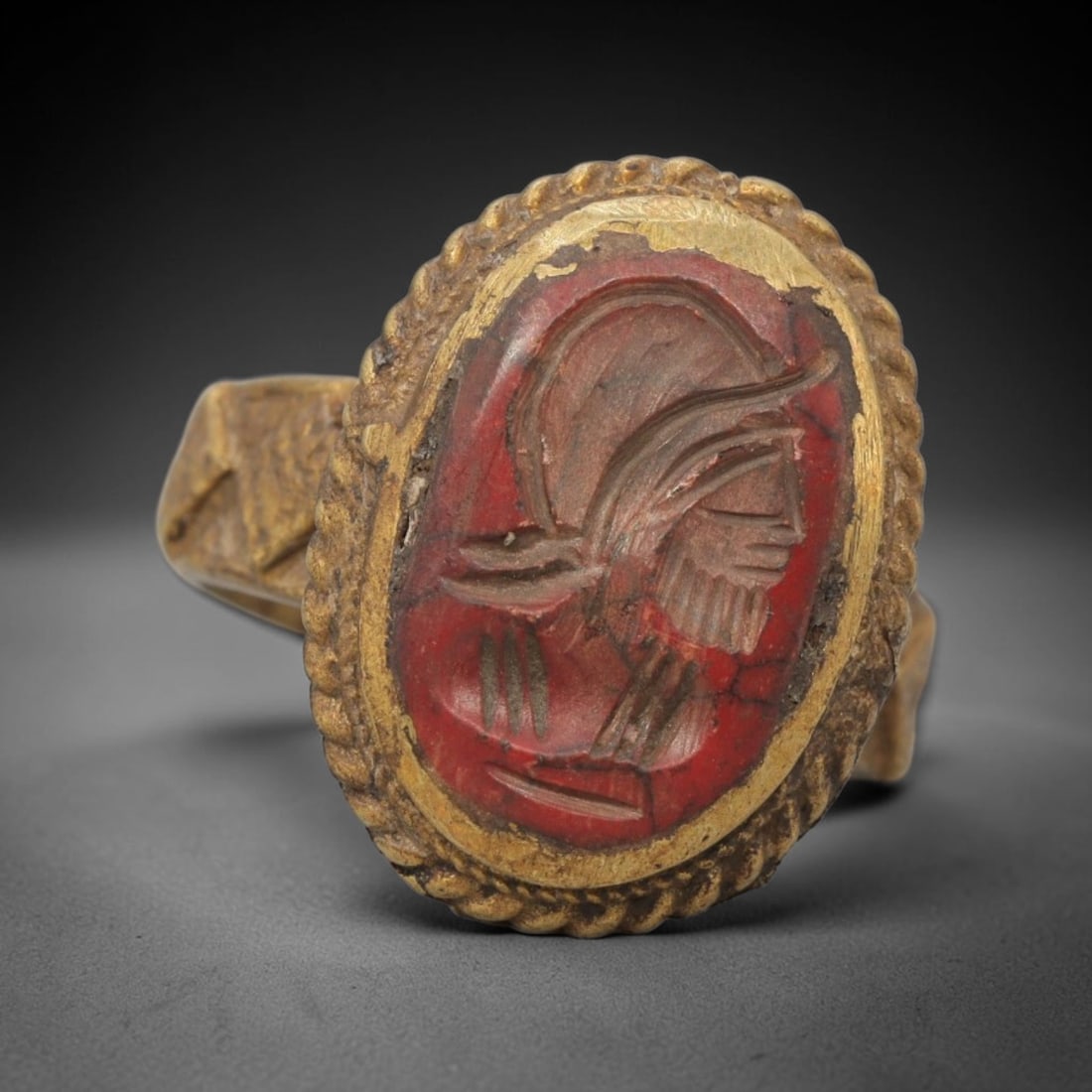 Antique Qajar Dynasty Brass Red Stone Intaglio Ring - Size 9 US, 87ZX: This antique Qajar dynasty brass intaglio ring features an oval red stone intaglio inset carved with a detailed profile portrait of a bearded figure, set within an ornate brass mount with a twisted ro