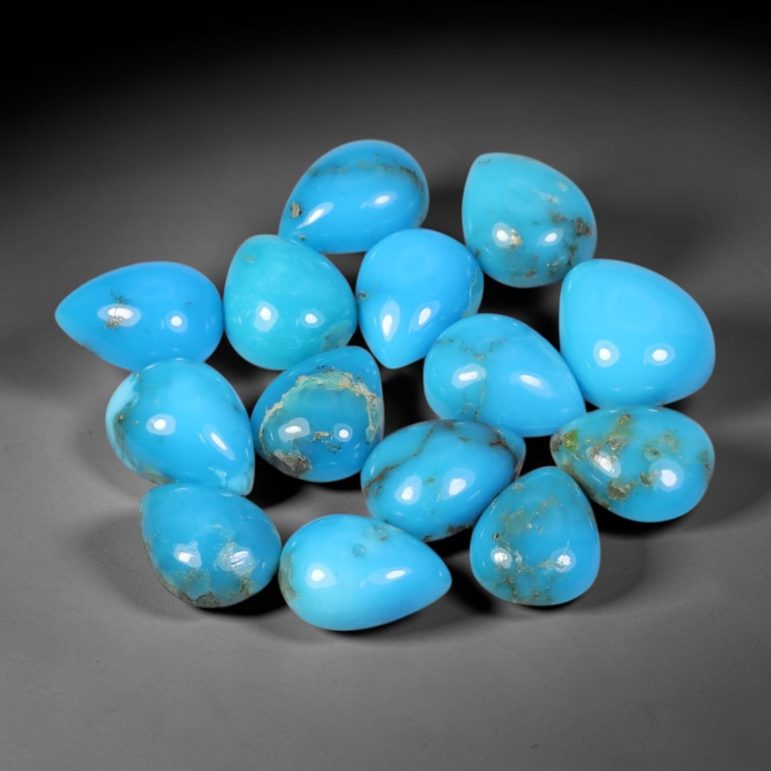 13.11 Carats Natural Turquoise - Pear Cabochon Gemstone, 12XB: Pear cabochon-cut turquoise gemstone, crafted from natural turquoise material. The stone displays a vibrant sky-blue to turquoise hue, with natural matrix inclusions and subtle veining characteristic