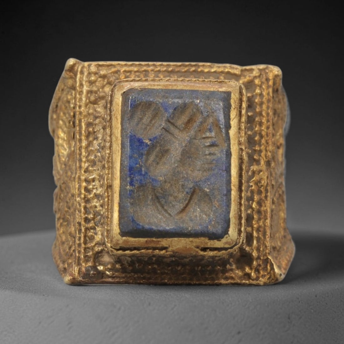 Antique Qajar Dynasty Lapis Lazuli Intaglio Ring - Size 7 US, 88ZX: This antique Qajar dynasty brass intaglio ring features a rectangular lapis lazuli intaglio inset carved with a detailed profile portrait, set within an ornate square brass mount adorned with granular