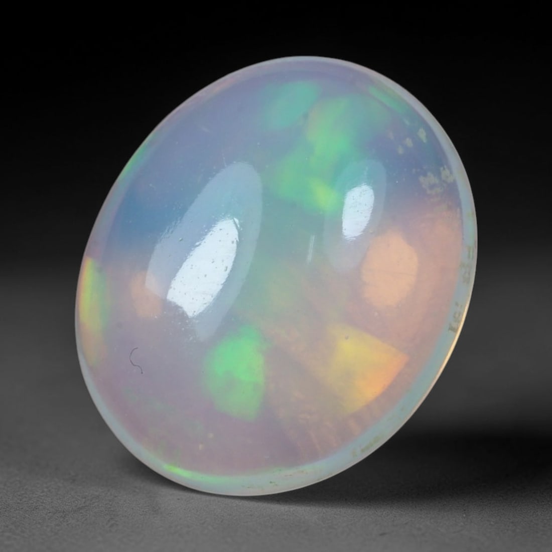 4.92 Carats Natural Ethiopian Welo Opal - Oval Cabochon Loose Gemstone, 25XB: Natural oval cabochon Welo opal, sourced from the premium Welo deposit in Ethiopia. This exceptional single stone features a translucent, milky white base alive with vivid, full-spectrum play-of-color