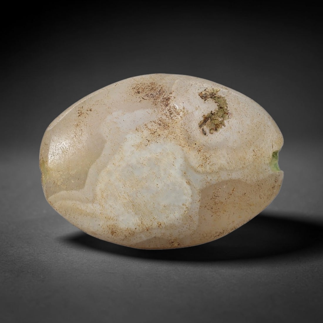 Ancient Large Banded Agate Bead - Near Eastern Artifact, 72BC: This artifact is crafted from natural banded agate, shaped into a substantial rounded oval (barrel) form with a pale milky-white base and subtle swirling banding patterns. The bead features a central