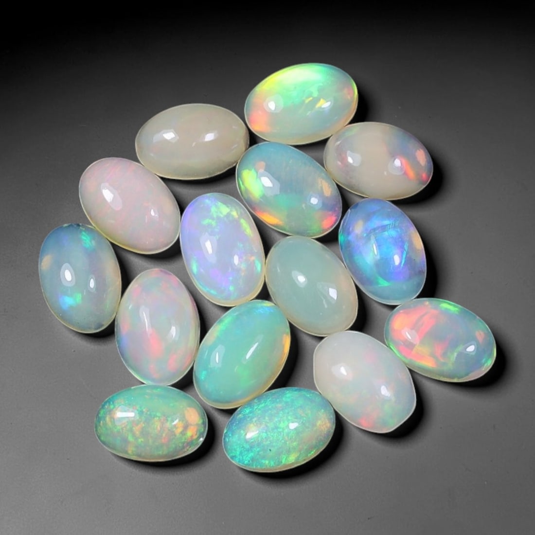4.62 Carats Natural Ethiopian Welo Opal - Oval Cabochon Loose Gemstone Lot, 60WE: Natural oval cabochon Welo opal lot, sourced from the premium Welo deposit in Ethiopia. This curated collection showcases exceptional opals with vivid, full-spectrum play-of-color-flashing fiery reds,
