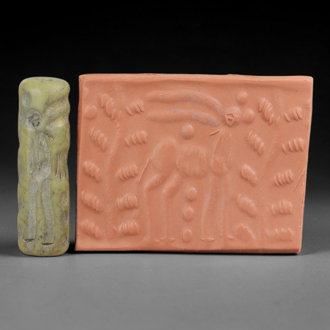 Ancient Serpentine Cylinder Seal - Mesopotamian Ibex Motif, 72FX: Carved from serpentine, this cylinder seal follows the classic cylindrical form of ancient Mesopotamian administrative artifacts. Its surface bears a detailed figural scene, featuring a central ibex f