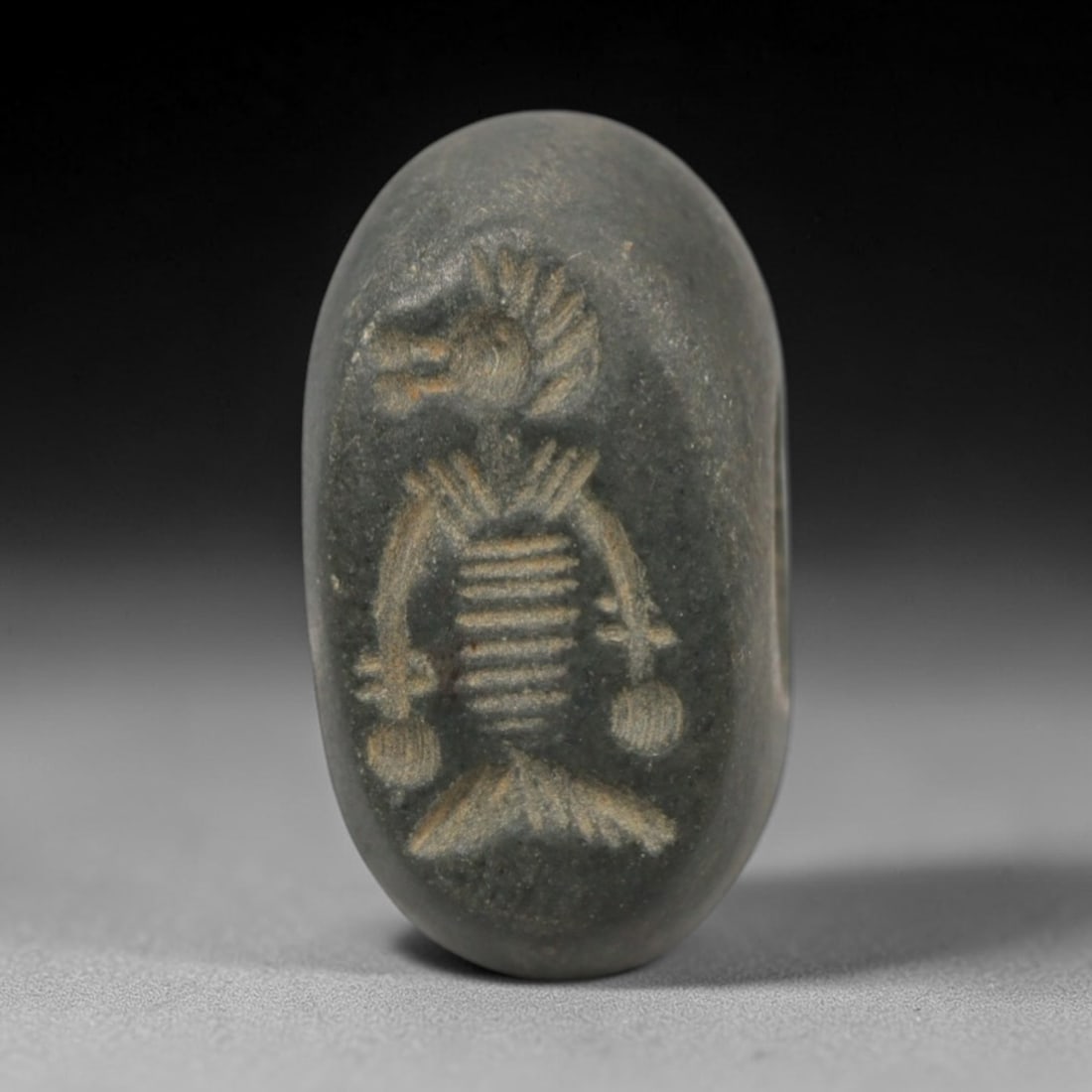 Ancient Stone Hemispherical Stamp Seal - Near Eastern Mythical Figure, 10ZT: Crafted from dense, fine-grained dark stone, this hemispherical stamp seal bears precise incised carving of a mythical anthropomorphic figure, featuring a stylized animal head, ribbed torso, segmented
