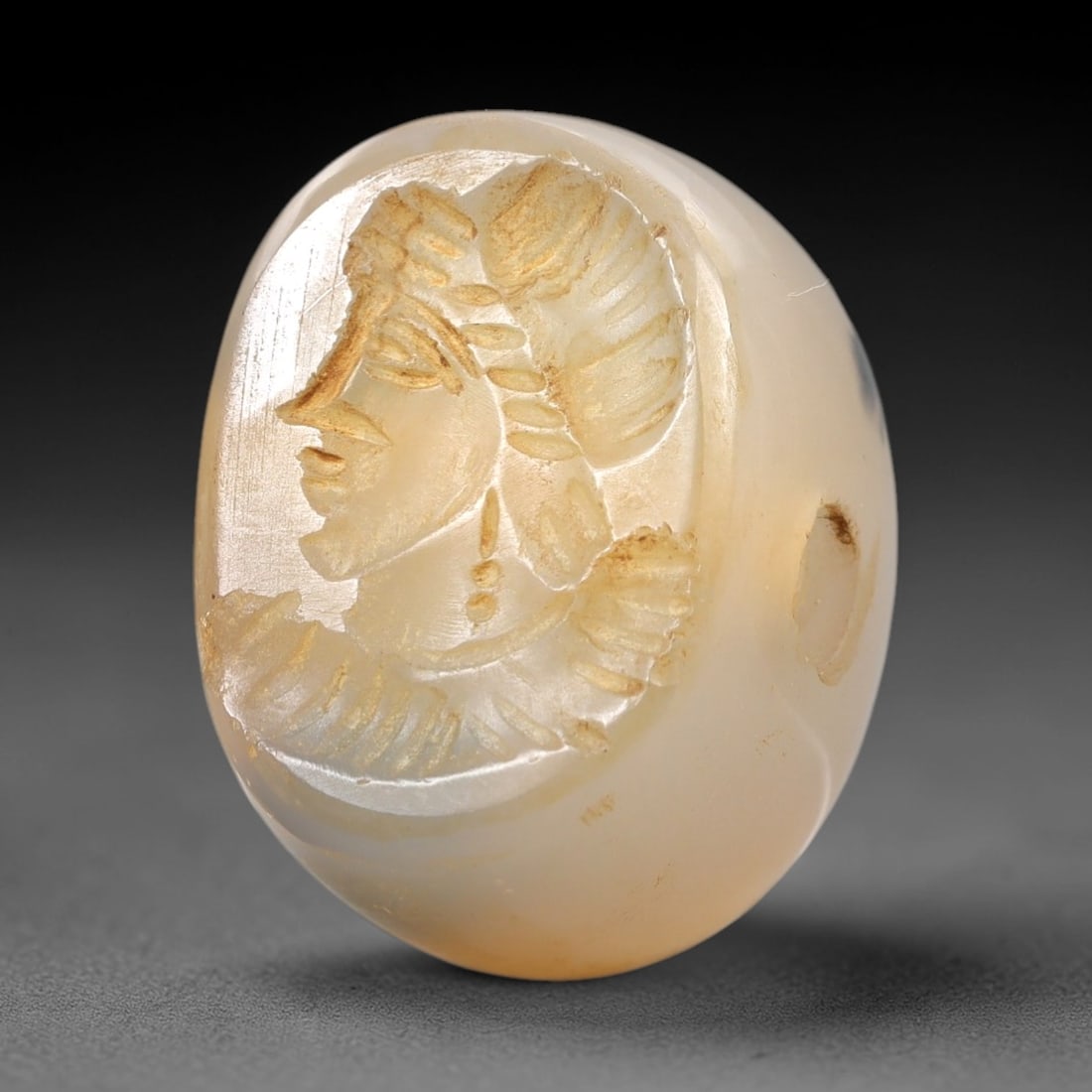 Ancient Chalcedony Hemispherical Stamp Seal - Near Eastern Noble Amulet, 8AN: This ancient Near Eastern hemispherical stamp seal is carved from translucent, creamy white chalcedony, with a smooth, polished surface and subtle natural inclusions. The seal's oval face depicts a st
