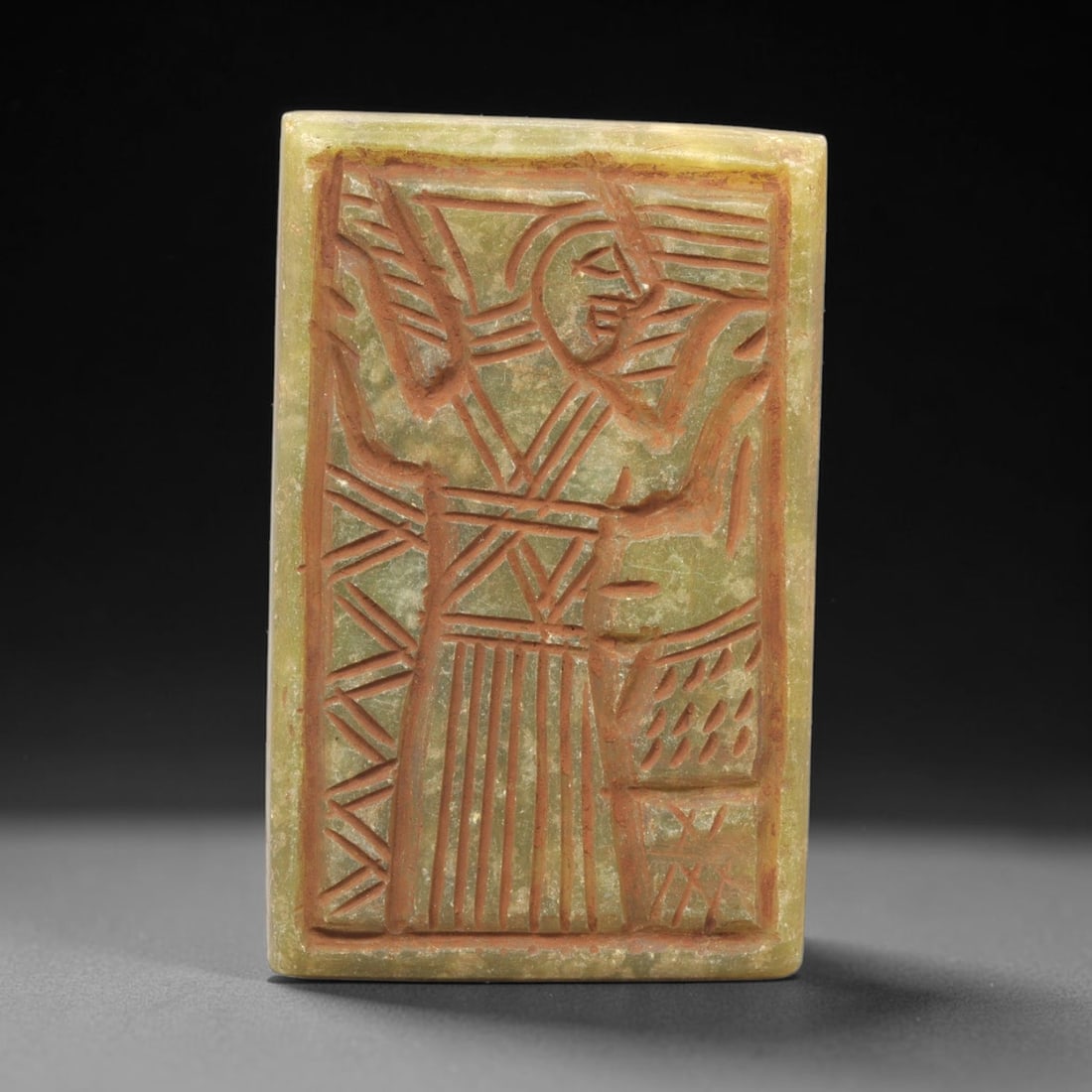 Near Eastern Serpentine Plaque - Tribal Art Single Figure Relief, 64ZY: Carved from serpentine, this rectangular plaque features a deeply incised relief depicting a single stylized anthropomorphic figure, executed with precise linear detailing characteristic of Near Easte