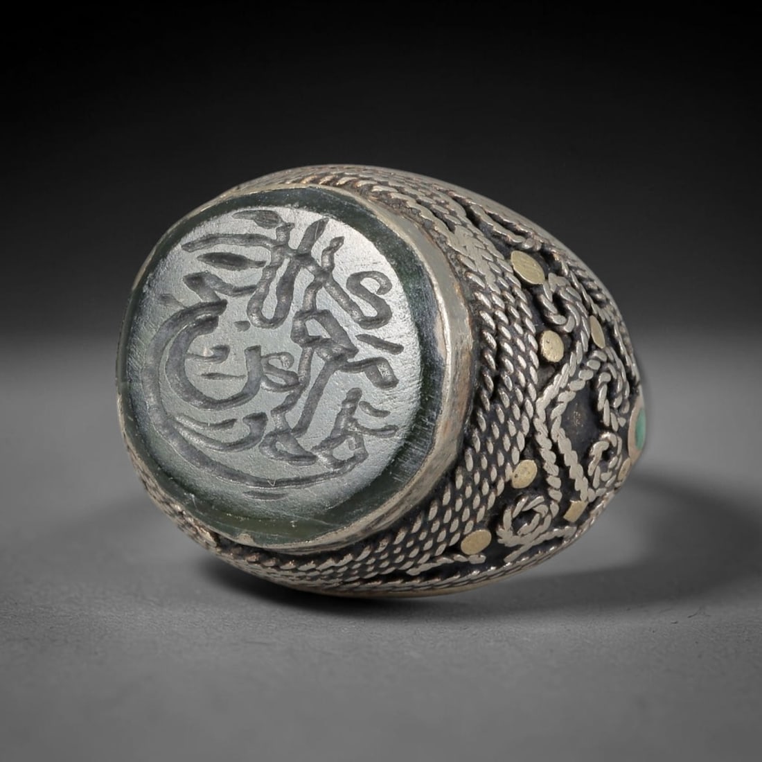 Antique Silvered Ring - Islamic Agate Calligraphic Intaglio, 8BK: Silvered metal ring featuring an oval agate cabochon carved with Islamic calligraphic intaglio, rendered with flowing Arabic script in the traditional Persian/Islamic artistic style. The bezel and ban