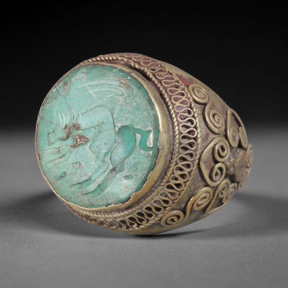 Antique Silvered Ring - Eurasian Steppe Turquoise Horse Intaglio, 99BH: This antique Eurasian Steppe ring is constructed from silvered metal with untested silver purity, exhibiting a warm brass-toned patina. The domed face features a turquoise cabochon carved with an inta