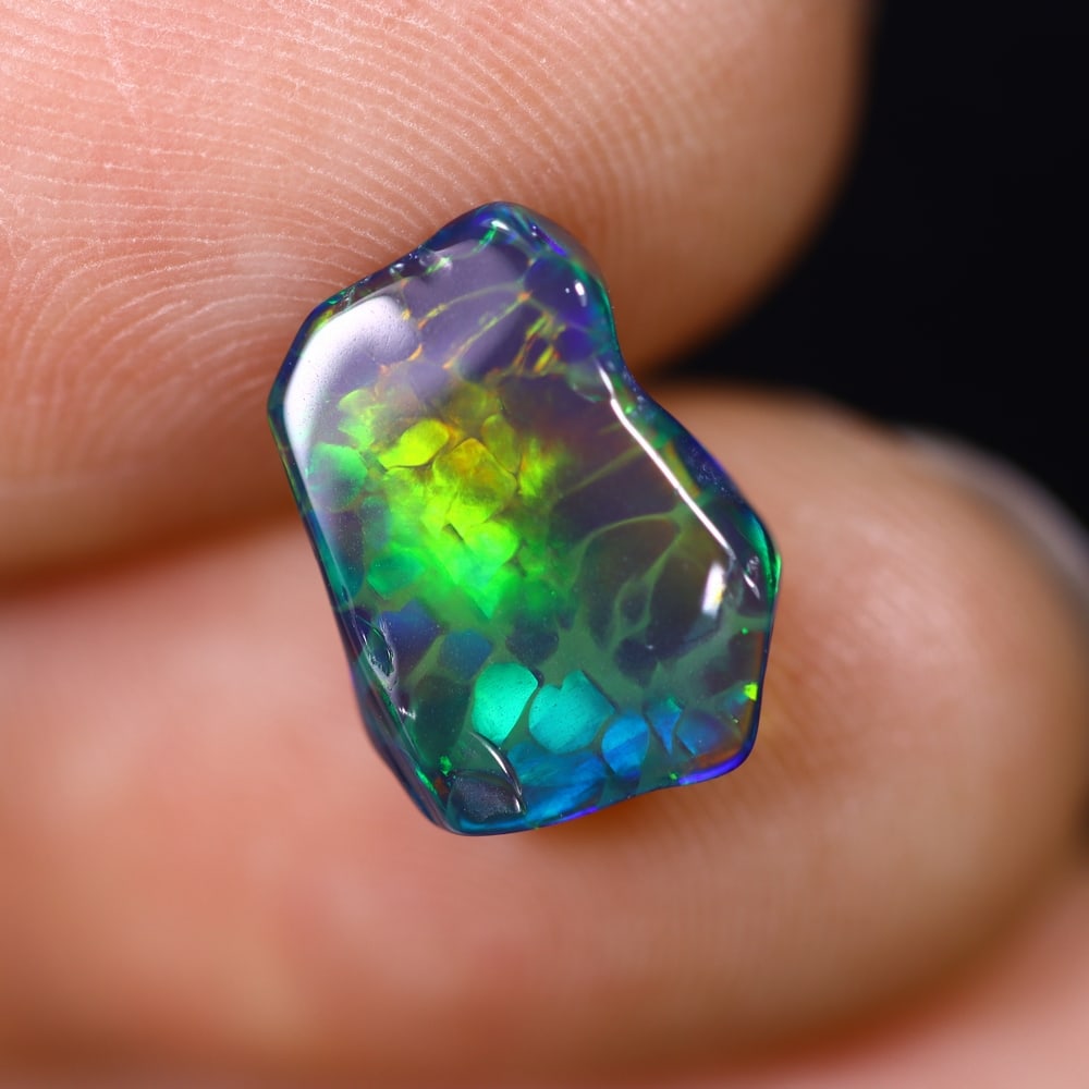 *2.05Ct Smoked Freeform Welo Opal Polished - Ethiopian Opal , 204C: ThousandPlanet Auction Subject: Natural Ethiopian Welo Opal Origin: Ethiopia Carat Weight: 2.05Ct Dimension: 12.3x9.1x4.5 mm Treatment: Smoked Type: Freeform, Polished