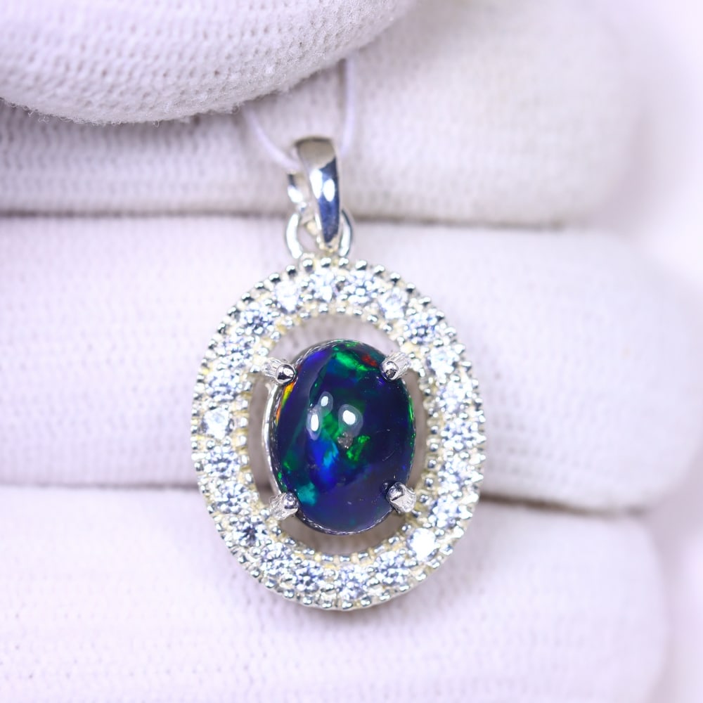 Silver Pendant with Ethiopian Black Opal 3.5grams - 925 Sterling Silver, 1207B: ThousandPlanet Auction Subject: Opal & Simulated Diamond Silver Pendant Carat Weight: 3.5 grams (approx.) Dimension: Opal 10x7mm, Pendant 22x15mm