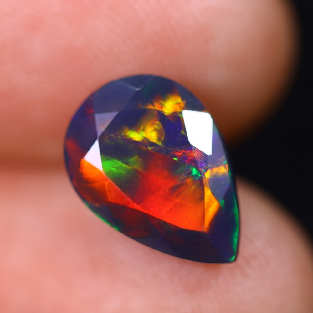 1.90Ct Welo Black Opal Faceted Polished - Ethiopian Opal , 824E: ThousandPlanet Auction Subject: Natural Ethiopian Welo Black Opal Origin: Ethiopia Carat Weight: 1.90Ct Dimension: 12x8.4x4.7 mm Treatment: Smoked Type: Faceted, Polished<