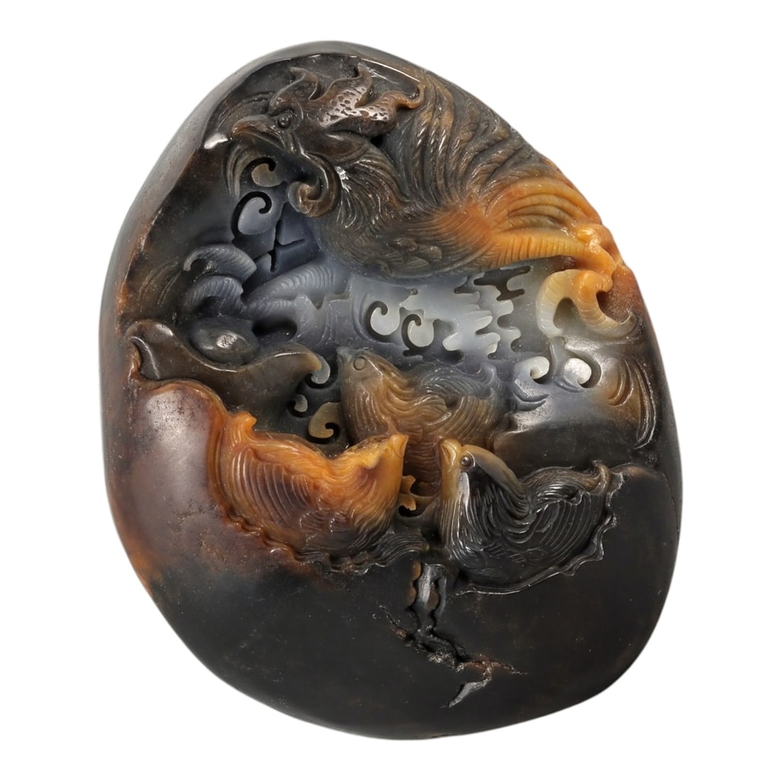 A Chinese Hetian Jade Phoenix and Bird Display Carving, 20th Century, 70FC: Carved from a single piece of dark-toned Hetian jade with dramatic russet and amber inclusions, this freestanding display carving is worked in high relief and openwork to depict a dynamic avian compos