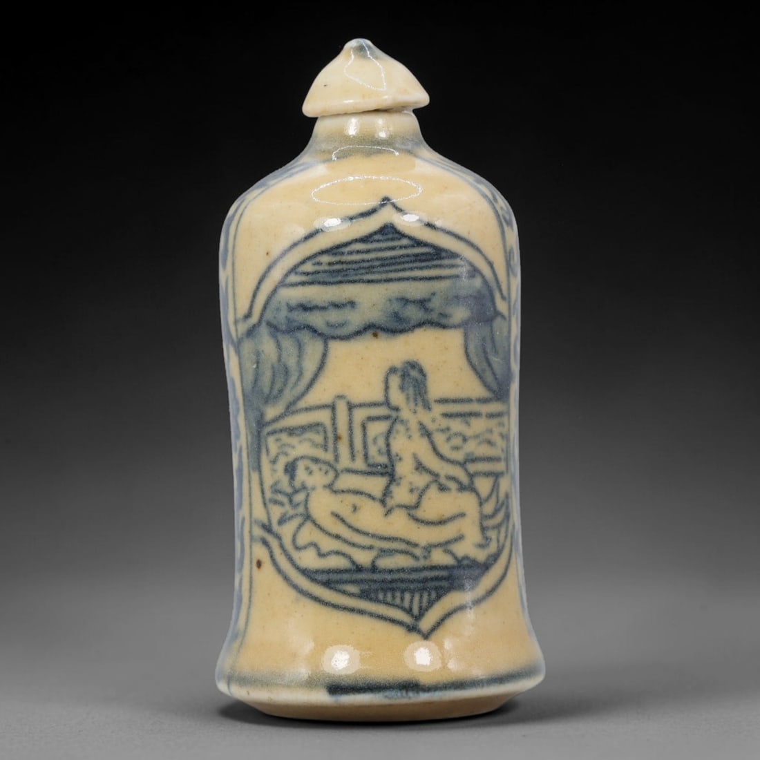A Chinese Porcelain Snuff Bottle, 20th Century, 58BE: Crafted from porcelain with a pale cream glaze and decorated in underglaze blue, the snuff bottle features a cylindrical, slightly flared body, a short neck, and a conical stopper. The main surface is