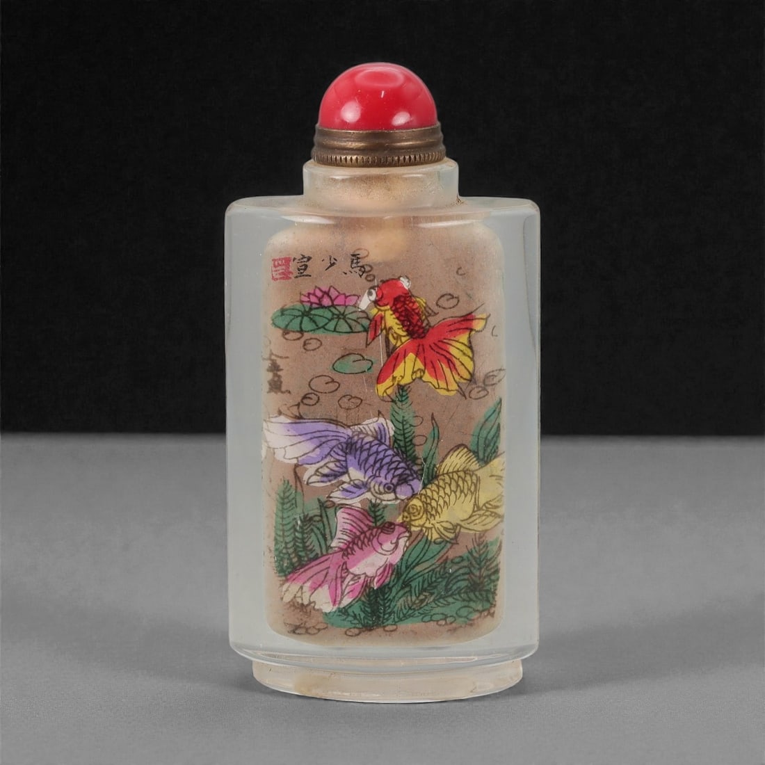 A Chinese Crystal Glass Inside-Painted Snuff Bottle, 20th Century, 57FG: The snuff bottle is formed from clear crystal glass and of flattened rectangular section, rising from a narrow recessed foot to a short cylindrical neck with a flat rim. The interior is painted with a