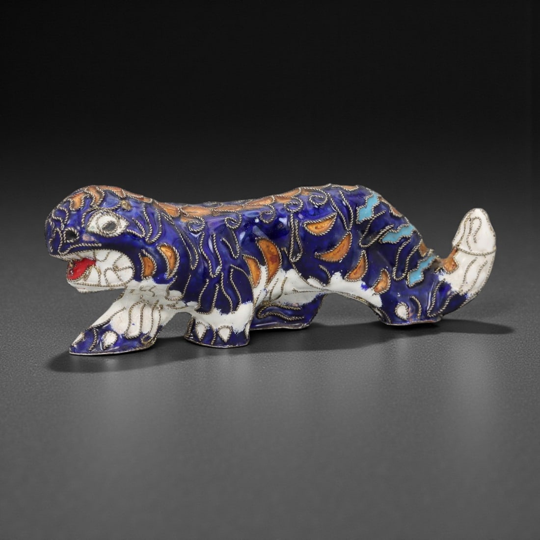 A Chinese Cloisonne Enamel Tiger Effigy, 20th Century, 4FH: Modeled as a striding tiger shown in profile with the body elongated and the head turned slightly forward, the effigy is constructed over a metal core and decorated overall with cloisonne enamel on a 