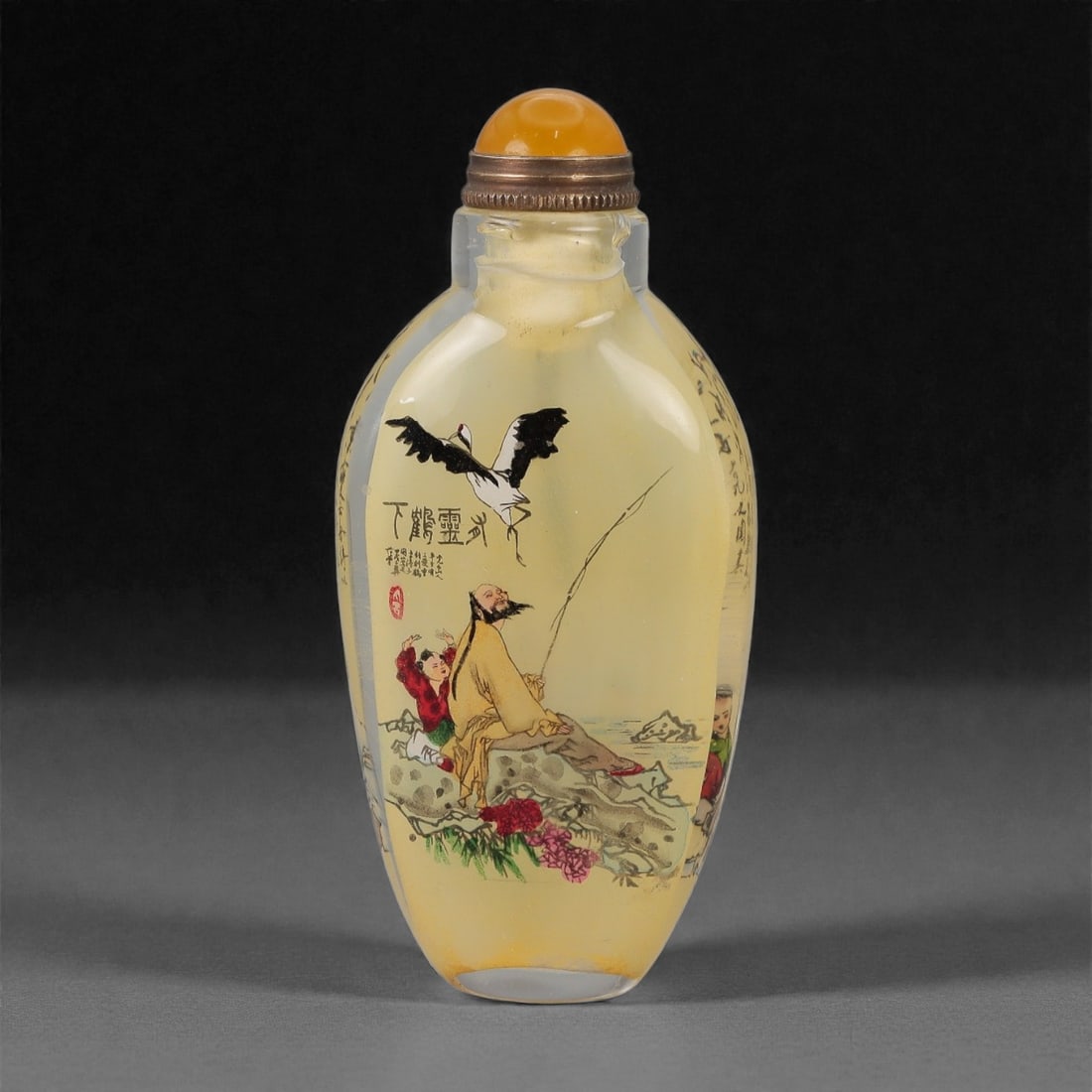 A Chinese Glass Inside-Painted Snuff Bottle, 20th Century, 54FG: The snuff bottle is formed from translucent pale amber glass and of elongated ovoid form, tapering gently from a rounded shoulder to a narrow foot, and rising to a short cylindrical neck with a flat r