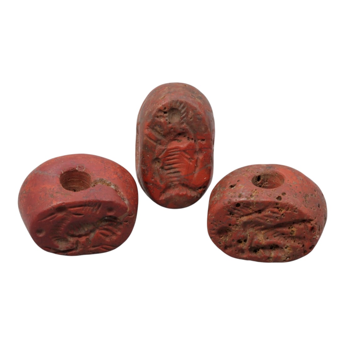 Lot of 3 Ancient Near Eastern Red Jasper Stamp Seals, Circa Late Antiquity, 3WM: A group of three hand-carved stamp seals crafted from red jasper, exhibiting the stone's rich, earthy red hue with natural mineral inclusions, alongside surface patination, wear, and subtle weathering