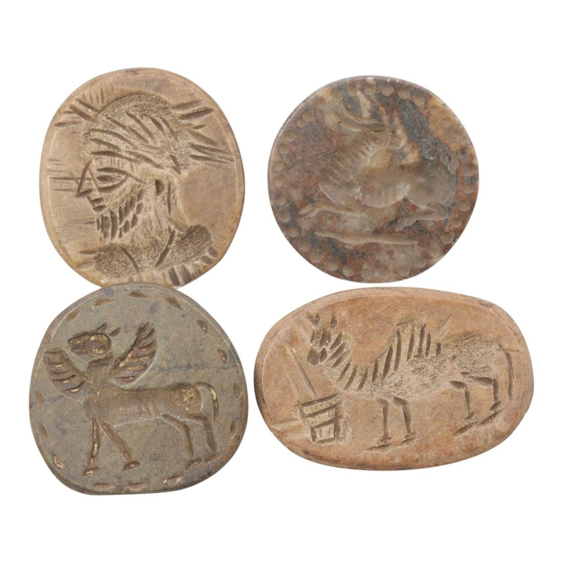Lot of 4 Ancient Near Eastern Steatite Stamp Seals, Sasanian Period, 77WM: A group of four steatite stamp seals from the Sasanian period, varying in form from circular to oval and irregularly shaped. The seals are carved from steatite in natural hues of light brown, grey, an