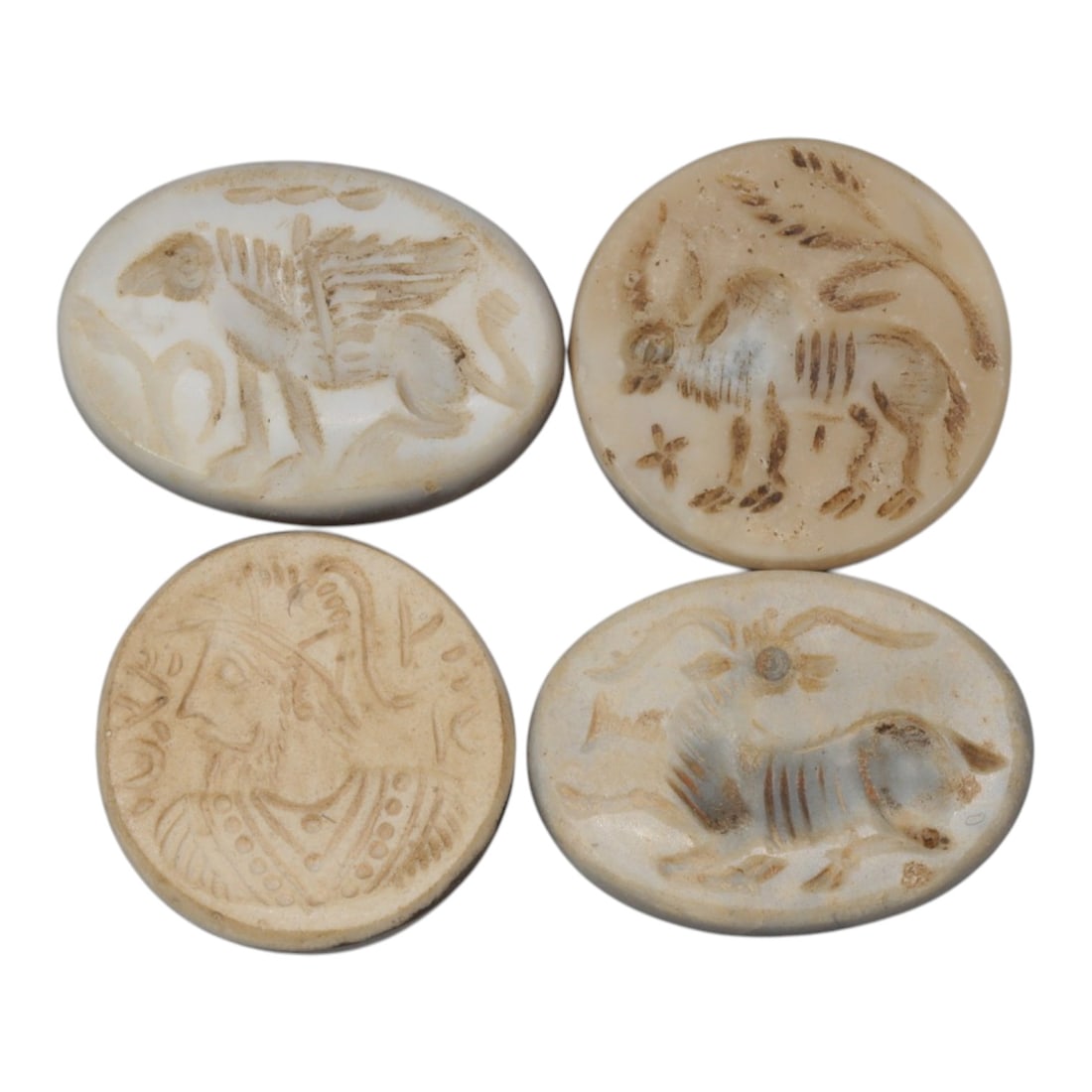 Lot of 4 Ancient Near Eastern Stone Intaglios, Circa Achaemenid to Sasanian Period, 48WM: A group of four oval stone intaglios from the ancient Near East, spanning the Achaemenid to Sasanian periods. Each is carved from light-toned stone, likely agate or chalcedony, with deeply incised mot