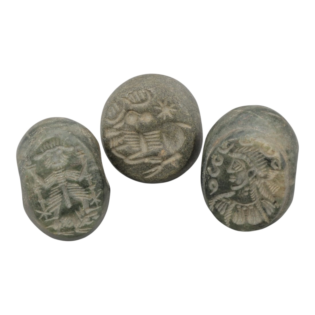 Lot of 3 Sasanian Stone Stamp Seals, Circa 3rd-7th Century CE, 2WM: A group of three Sasanian period stamp seals carved from dark green-grey stone, exhibiting natural patination, surface wear, and subtle weathering consistent with age. Each seal is of rounded, domed f