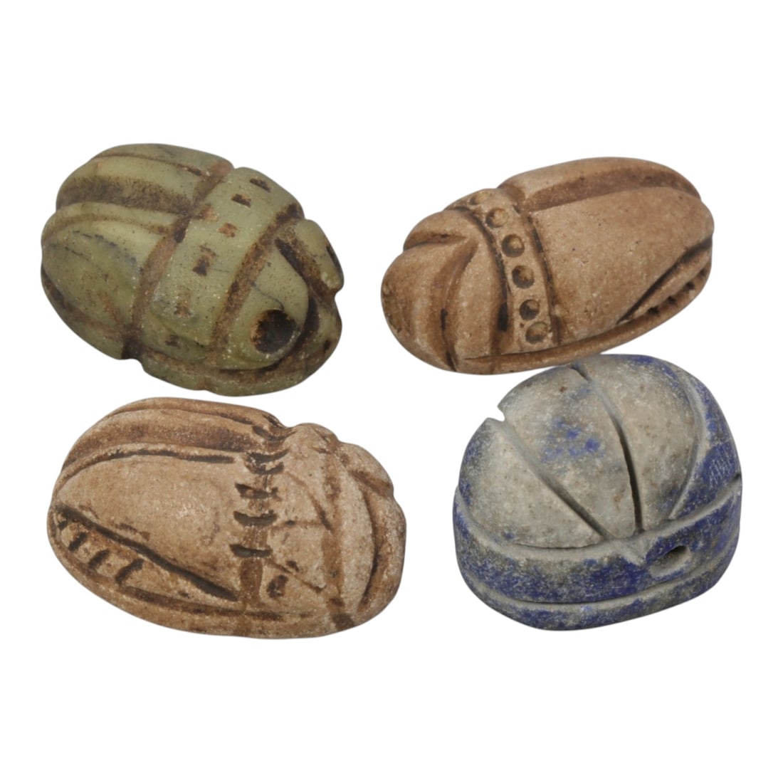 Lot of 4 Ancient Coptic Egyptian Stone Scarabs, Roman to Coptic Era, 95WM: A collection of four ancient Egyptian scarab amulets, carved from varied materials including greenish stone, light brown stone, and lapis lazuli. Each scarab is shaped in the form of a beetle, with in