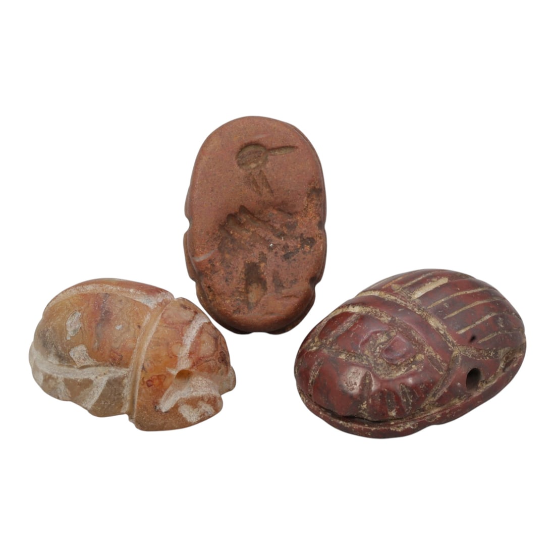 Lot of 3 Ancient Coptic Egyptian Stone Scarabs, Roman to Coptic Era, 42WM: A collection of three ancient scarabs, carved from reddish and light-toned stone (likely agate or jasper, consistent with Roman-Coptic period traditions). Each scarab is shaped in the form of a beetle