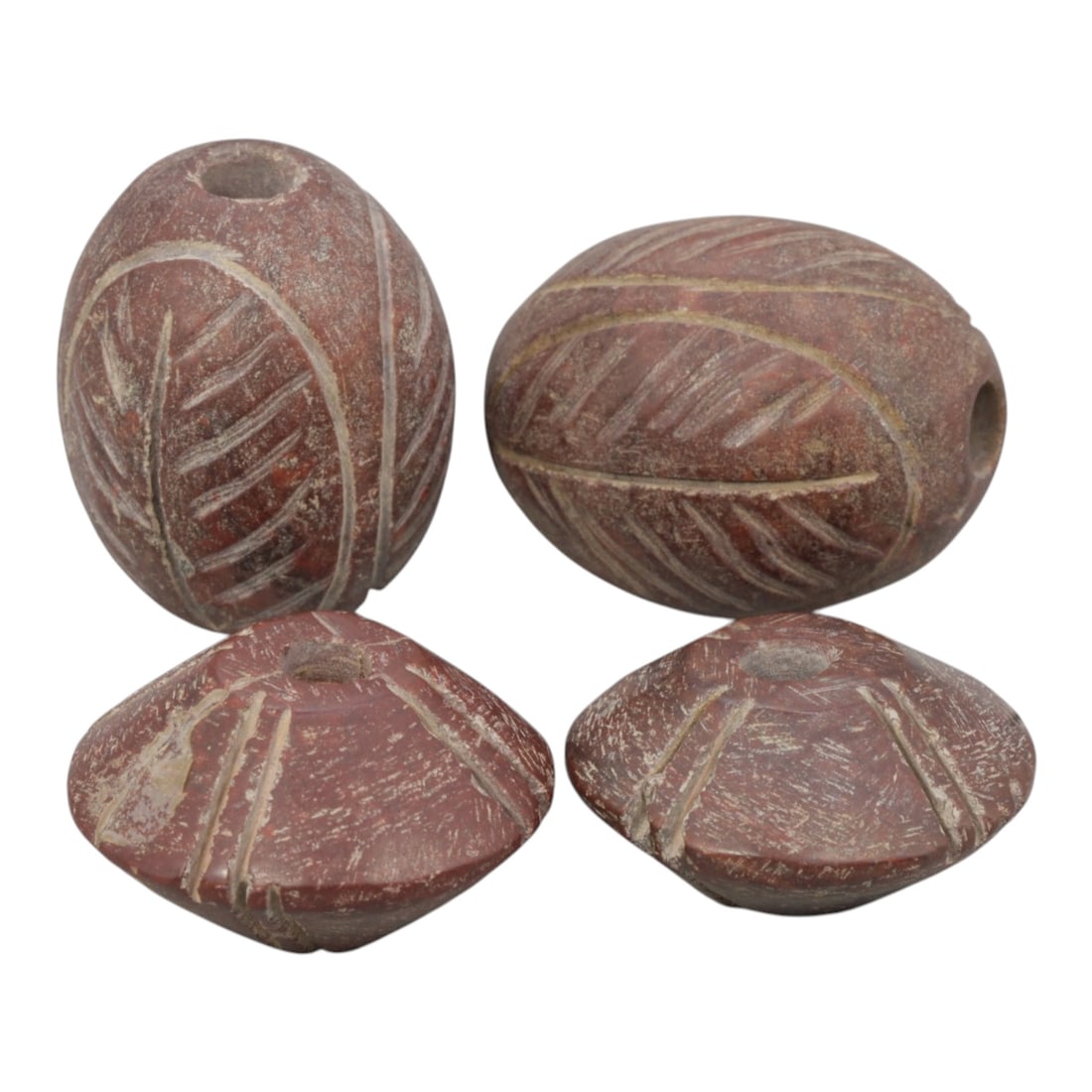 Lot of 4 Medieval Silk Road Jasper Beads, 72WM: A collection of four medieval beads, carved from deep red jasper, characteristic of Silk Road trade traditions. The set includes two oval beads with incised leaf patterns, and two disc-shaped beads wi
