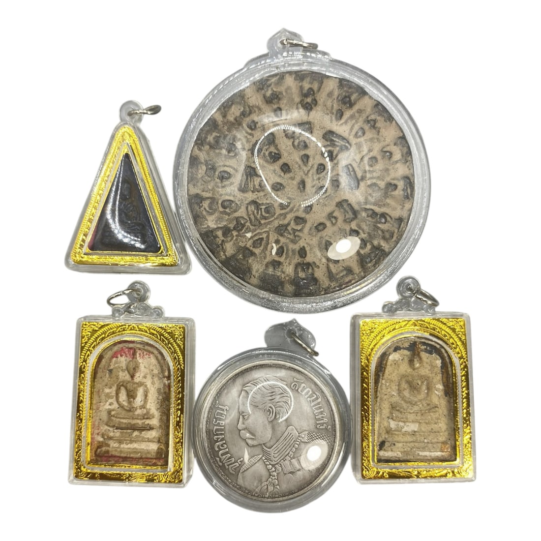 A Lot of 5 Vintage Thai Buddhist Amulets with Gold and Clear Cases, 11WT: A curated lot of five vintage Thai amulets, including Buddhist religious pieces and one commemorative coin amulet. The Buddhist amulets depict traditional seated Buddha iconography, with varying finis