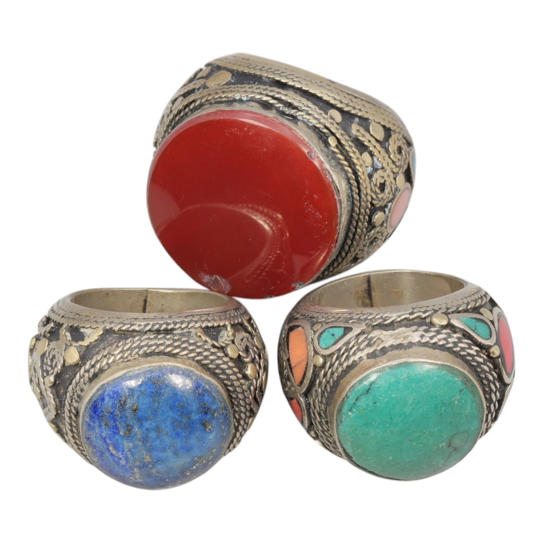 Lot of 3 Vintage Central Asian Tribal Silver Gemstone Rings, 53AD: A collection of three vintage tribal-style rings, characteristic of Central Asian folk jewelry traditions. Each ring is crafted from silver-toned metal with an aged patina, showcasing traditional twis