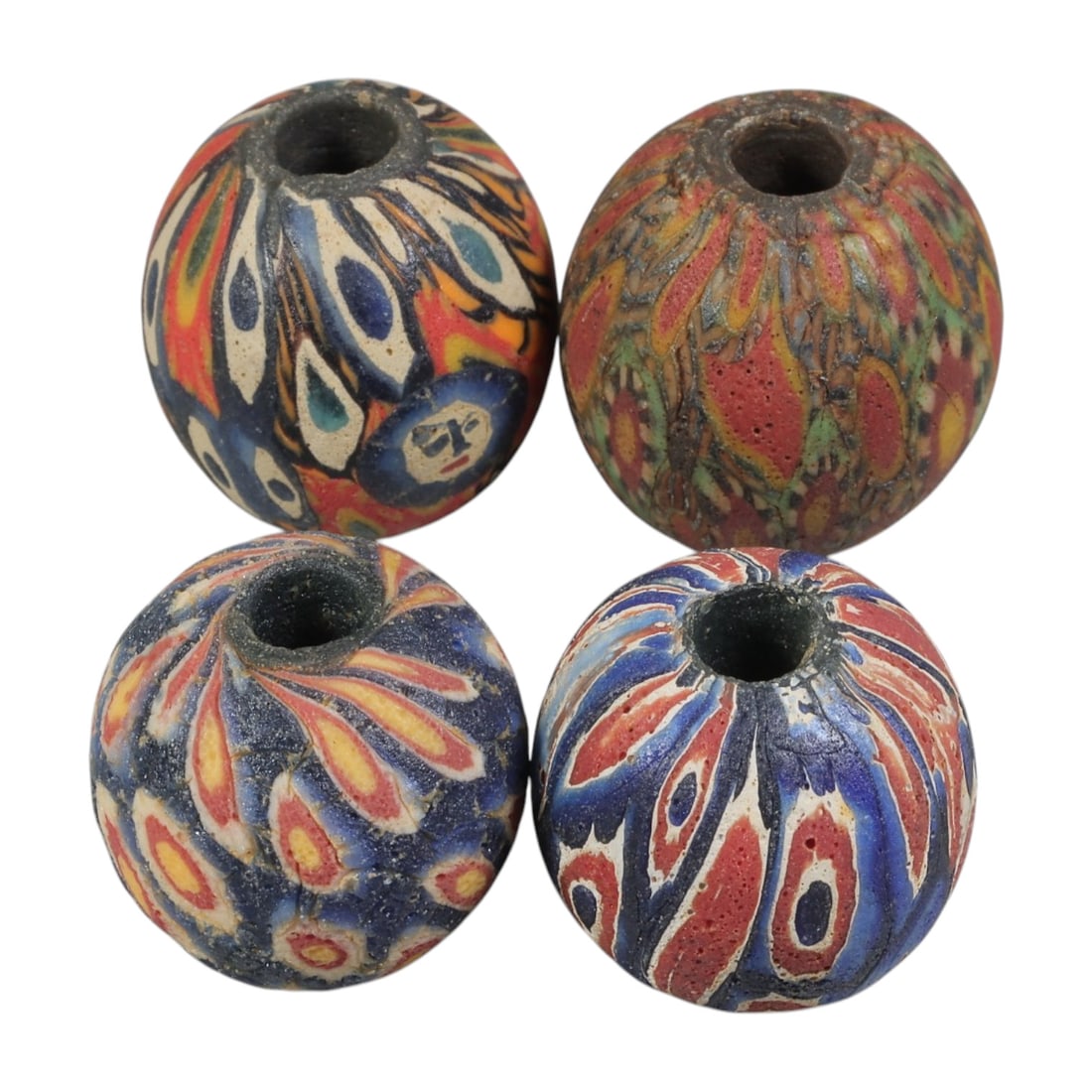 Lot of 4 Ancient to Antique Polychrome Glass Beads, 1st Mil BCE to Islamic Period, 37WM: A group of four spherical polychrome glass beads, each with a central perforation. The beads feature intricate mosaic and millefiori-style decoration, including eye motifs, flame patterns, and composi