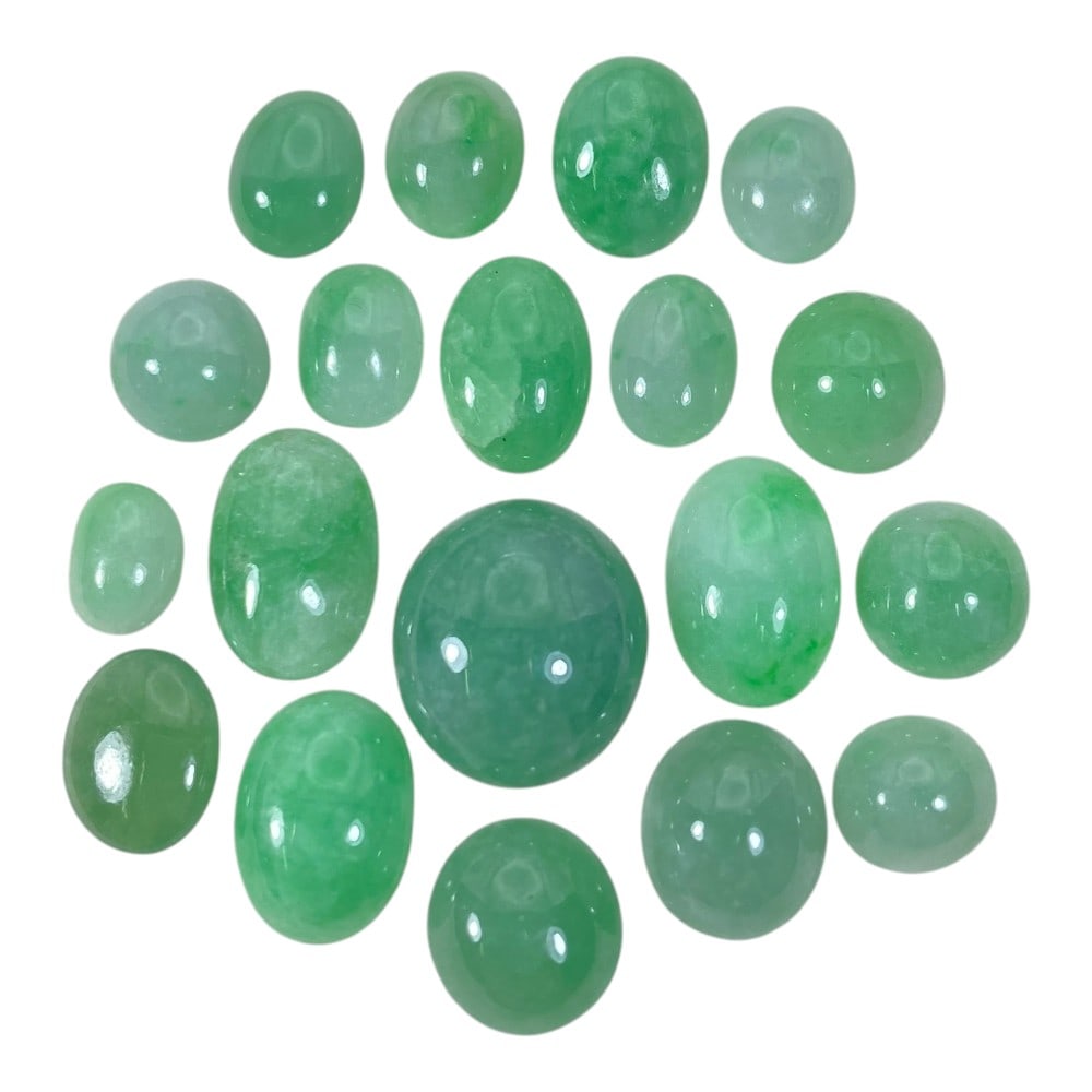 A Lot of 19 Natural Apple Green Jadeite Jade Cabochons, 69.70ct Total, 27AB: This collection comprises 19 polished jadeite jade cabochons in vibrant apple green hues, ranging from soft translucent tones to richer, saturated shades. The stones are primarily oval and round-shape