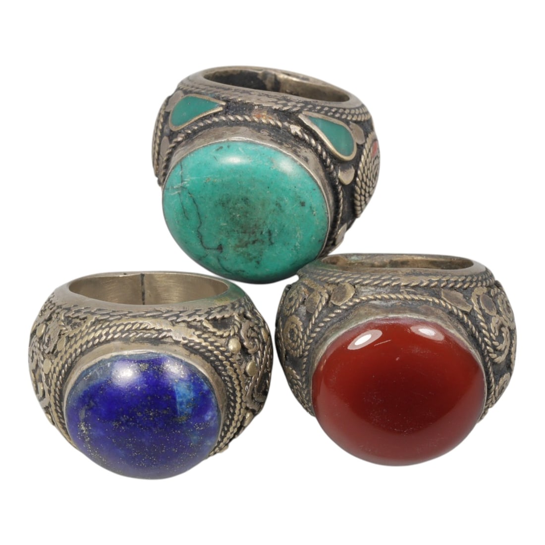 Lot of 3 Vintage Central Asian Tribal Silver Gemstone Rings, 47AD: A collection of three vintage tribal-style rings, characteristic of Central Asian folk jewelry traditions. Each ring is crafted from silver-toned metal with an aged patina, showcasing traditional twis