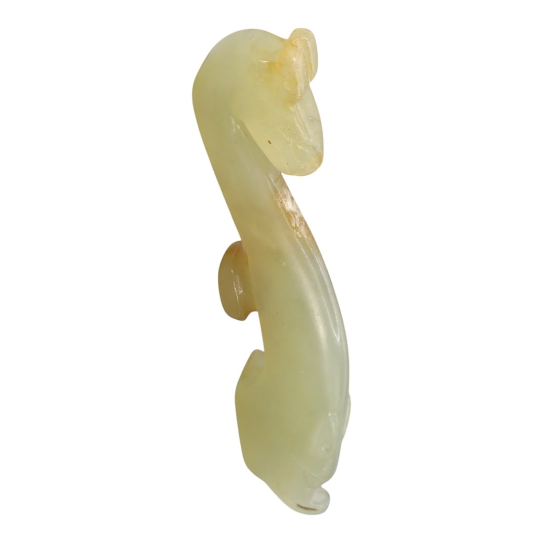 A Chinese Hetian Jade Zoomorphic Ornament, 20th Century, 80FH: Carved from pale celadon-toned Hetian jade, the ornament is rendered in a stylized zoomorphic form with an elongated, sinuous body rising in a gentle curve. The head is subtly defined with a rounded s