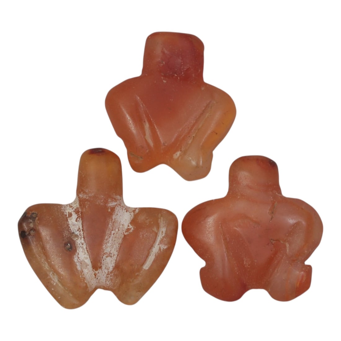 Lot of 3 Ancient Coptic Egyptian Carnelian Zoomorphic Amulets, c. Roman Period to Coptic Era, 25WL: Carved from warm, translucent carnelian with natural orange-red hues and subtle weathering, this set includes three stylized zoomorphic amulets, likely representing avian or abstract forms, each with 