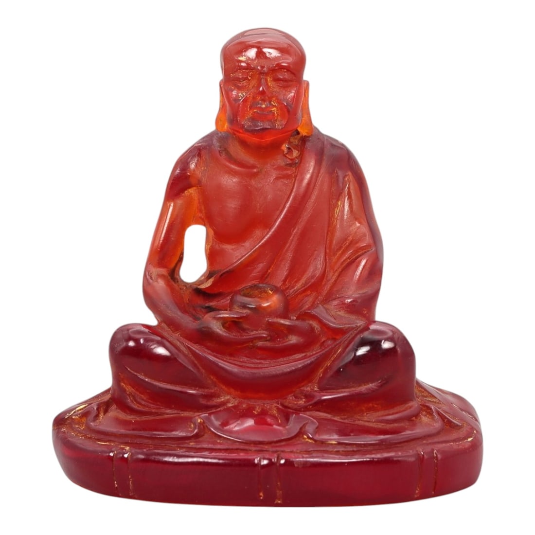 A Chinese Amber-Resin Figure of a Luohan, 20th Century, 38FH: TitleA Chinese Amber-Resin Figure of a Luohan, 20th CenturyDescriptionCast or carved from translucent red amber-colored resin with internal tonal variation and localized inclusions, the figure represe