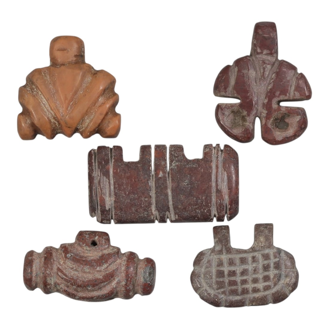 Lot of 5 Ancient Coptic Egyptian Red Stone Amulets, Circa Roman to Coptic Era, 39AE: The group comprises five carved red stone amulets of varied forms, including stylized geometric and zoomorphic shapes. All are worked from red stone with natural patination and surface wear consistent