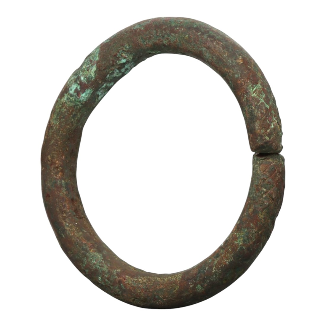 Ancient Bronze Bracelet - Roman Decorated Penannular Bangle, 83BN: A penannular bronze bracelet of ancient Roman origin, formed from a thick, rounded bronze band. The open terminals bear incised geometric motifs, providing subtle decorative detail characteristic of R