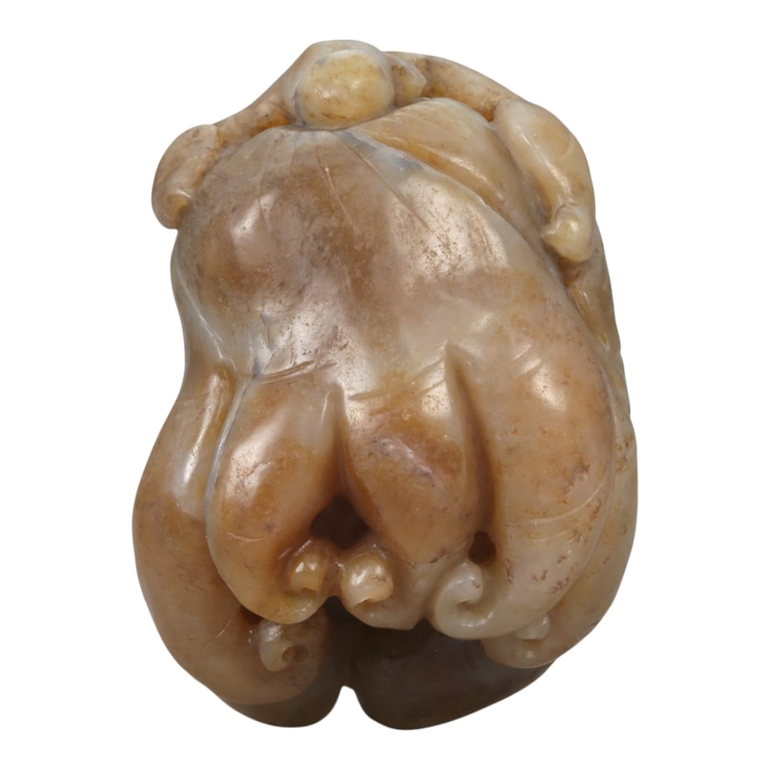 A Chinese Jade Ginseng-Form Pendant, 20th Century, 32YA: Carved from pale brown jade with areas of creamy translucency and natural surface mottling, the pendant is worked in the round in the form of a ginseng root. The main body is modeled as a bulbous cent