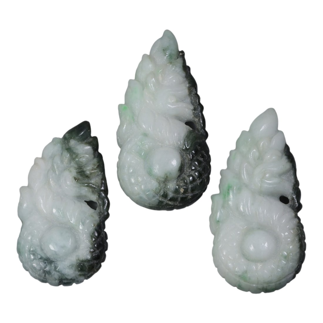 Lot of 3 Vintage Oriental Chinese Jadeite Jade Naga Pendants, 35AG: Carved from variegated jadeite jade with natural white, dark green, and light green inclusions, the three pendants each depict a coiled naga form. The dragon-like figures are carved in relief with sca