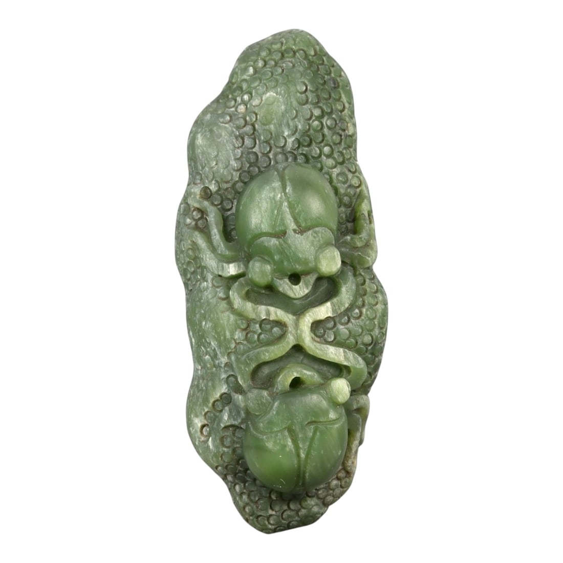 A Chinese Nephrite Jade Spider Carving, 20th Century, 33FA: Carved from green nephrite jade with areas of translucency and darker inclusions, the object is modeled as a spider rendered in relief against an irregular ground. The body is centrally positioned, wi