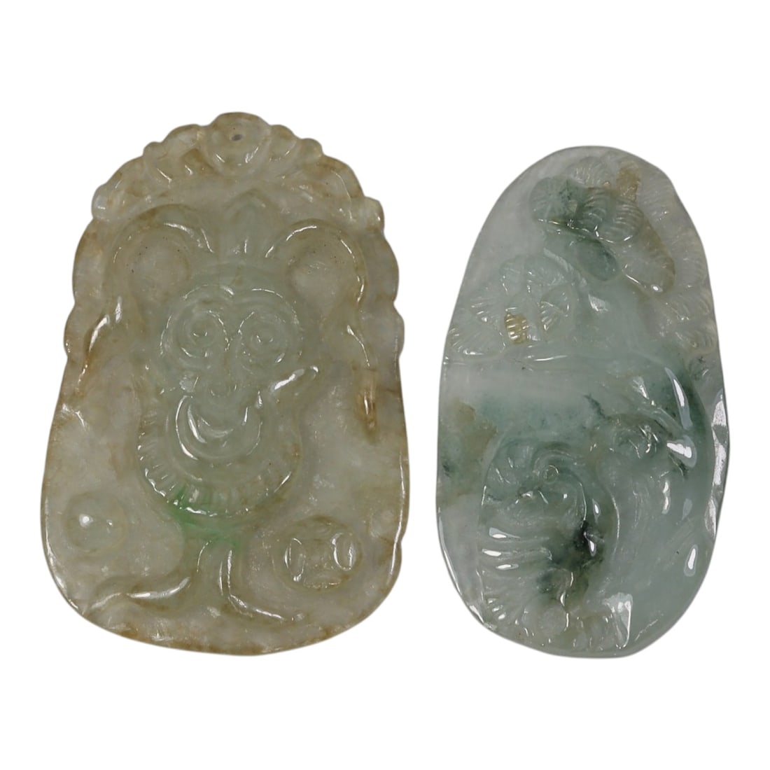 Lot of 2 Antique Oriental Chinese Jadeite Jade Pendants, 20AG: The left pendant is carved from translucent light green and yellowish-brown jadeite with subtle green inclusions, featuring a stylized monkey motif holding a coin, flanked by additional coin elements 