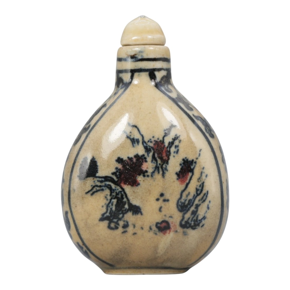 A Chinese Porcelain Snuff Bottle, 20th Century, 3YD: Crafted from porcelain with a pale cream glaze and decorated in underglaze blue with copper red accents, the snuff bottle features a flattened, pear-shaped body, a short cylindrical neck, and a domed 
