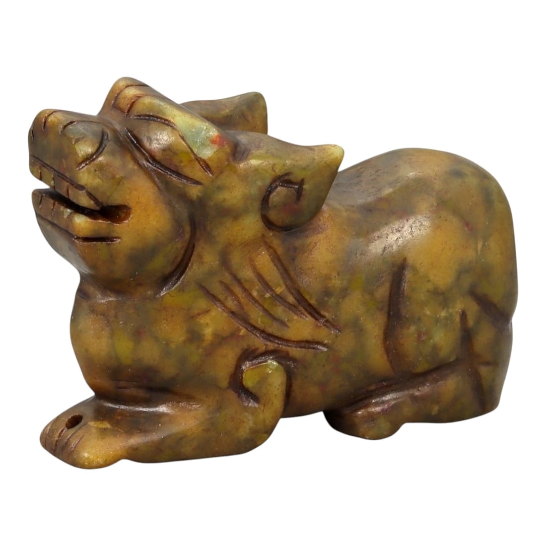 A Chinese Hardstone Pixiu Figure, Qing Dynasty, 19th Century, 17YB: Carved from mottled brown and yellow-toned hardstone, possibly soapstone, the figure represents pixiu, the mythical hybrid creature associated with wealth and protection. The animal is shown recumbent