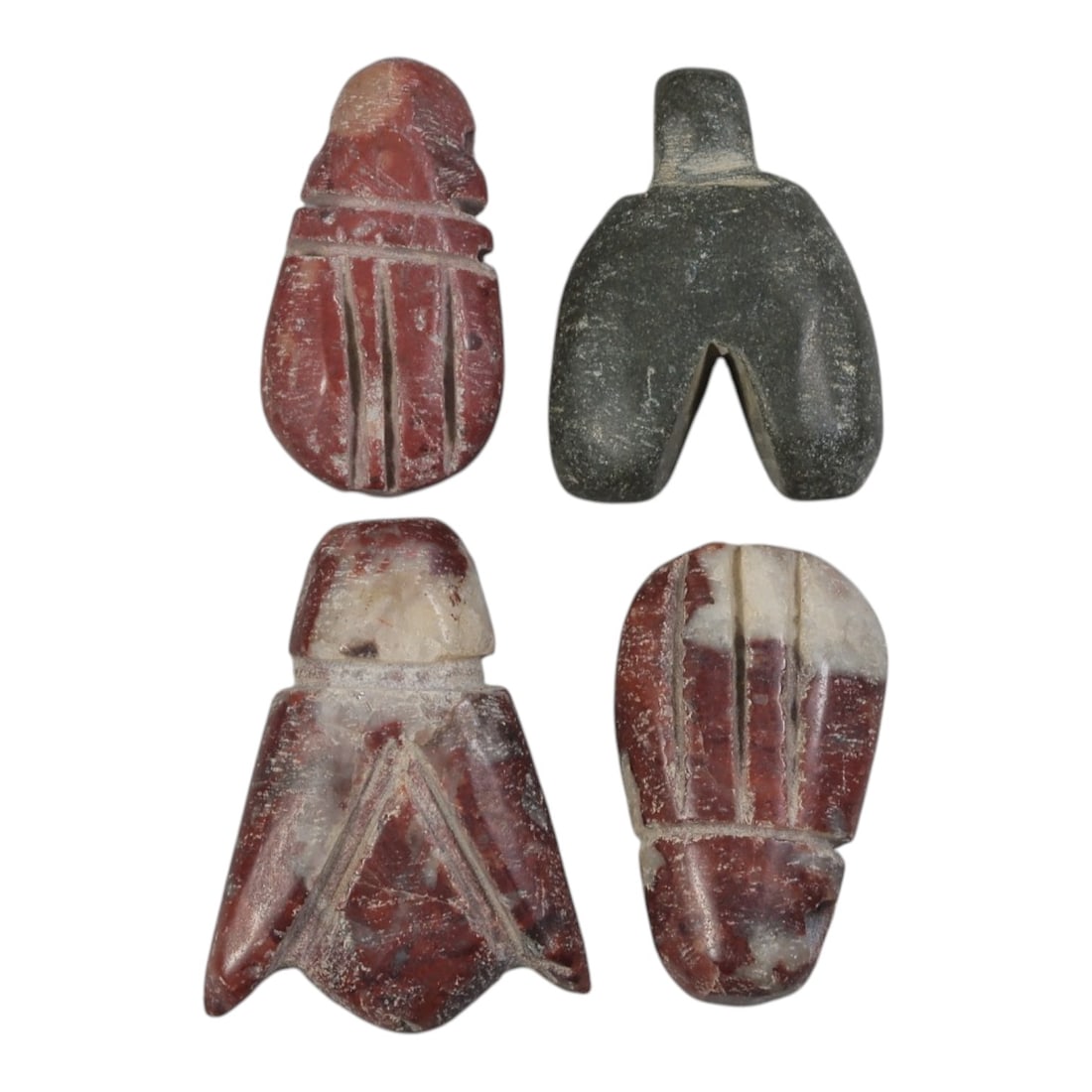 Lot of 4 Ancient Coptic Egyptian Red and Green Stone Fly Amulets, Circa Roman to Coptic Era, 88AE: The group comprises four carved stone fly amulets, each with stylized wing and body details rendered in incised lines. Three examples are worked from red and variegated red-and-white stone, while one 