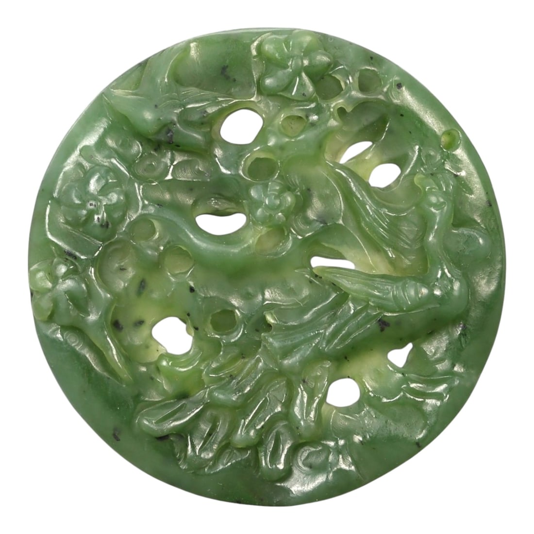 A Chinese Green Nephrite Jade Openwork Pendant Carved with Birds and Phoenix, 20th Century, 45FA: Carved from translucent spinach-green nephrite jade with lighter apple-green areas and scattered dark mineral inclusions, the pendant is of circular disc form and worked in openwork relief on one face