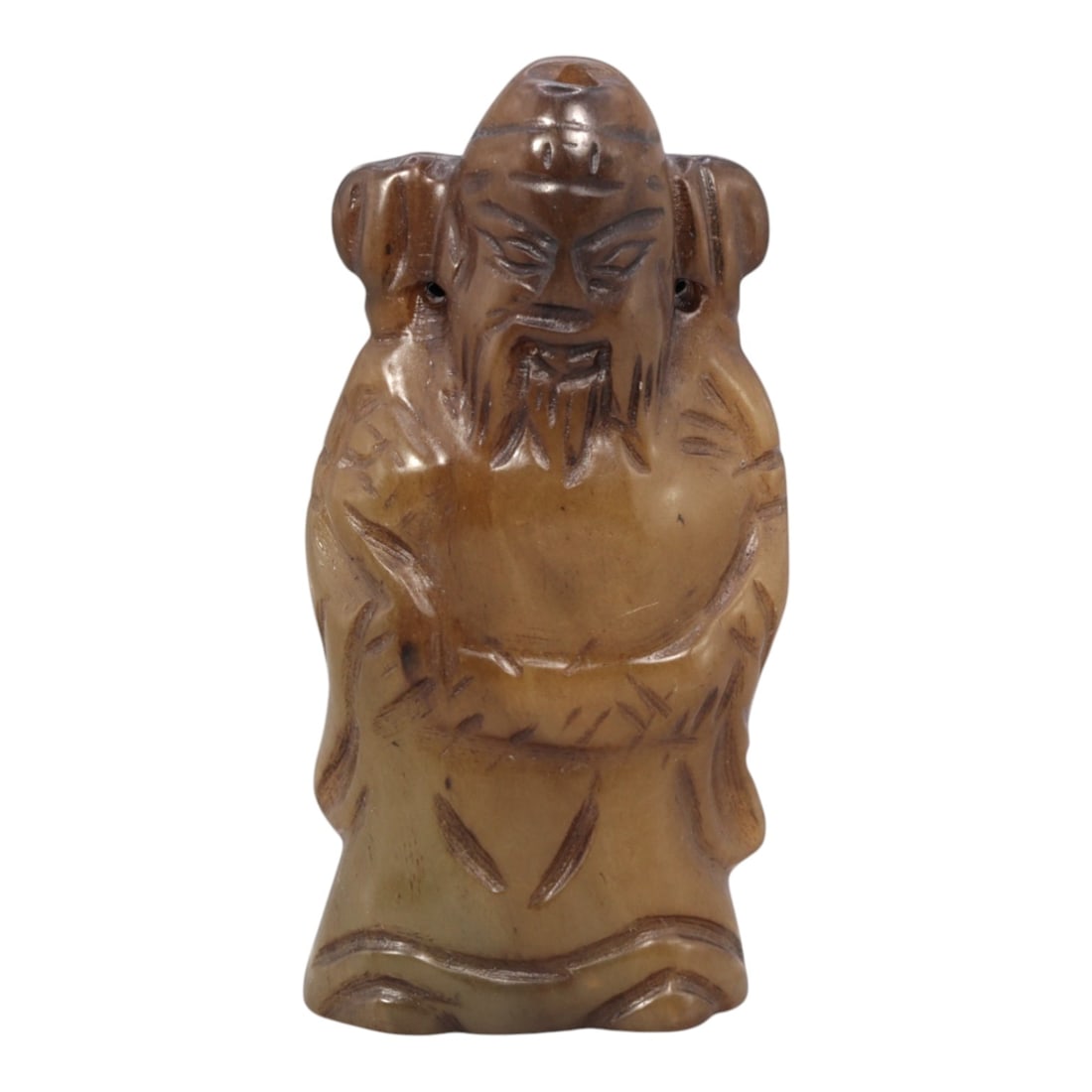 A Chinese Hetian Jade Figure, 20th Century, 86FH: Carved from Hetian jade with warm honey-brown and pale beige tonal variation, the figure is worked in the round and stands upright on a gently flattened base. The subject is shown wearing long robes w