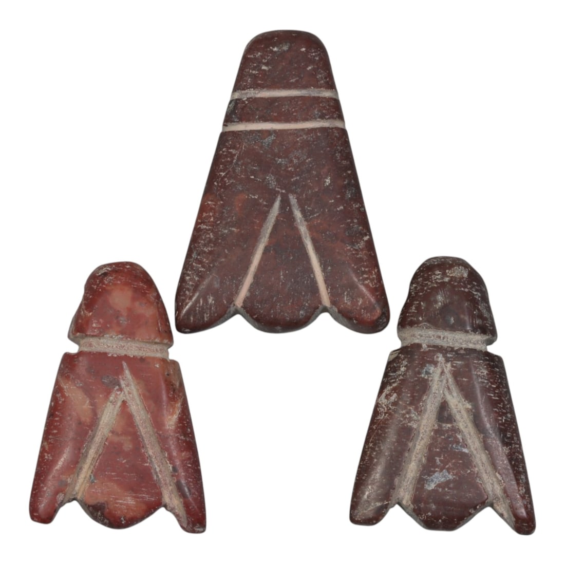 Lot of 3 Ancient Coptic Egyptian Red Stone Amulets, Circa Roman to Coptic Era, 12WL: Carved from deep red stone with contrasting light incised detailing, this trio of amulets features stylized leaf or bud forms, each with a drilled suspension hole confirming their use as wearable prot