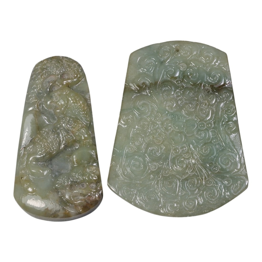 Lot of 2 Vintage Oriental Chinese Jadeite Jade Plaques, 29AG: The lot comprises two trapezoidal jadeite plaques, both carved from greenish jadeite with natural mottling and tonal variations. The left plaque features high-relief carving of a mythical beast, likel